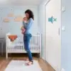 Woman holding baby next to ECLISSE Acoustic Sound-Proof Pocket Door Frame Kit