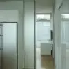 A Glass door hung with CS Cavity Slider Glass Clamps, half open
