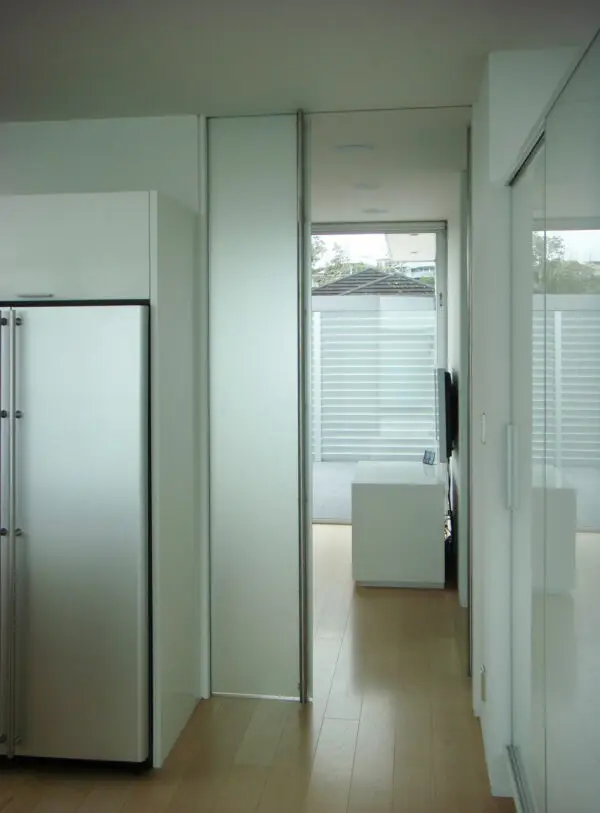 A Glass door hung with CS Cavity Slider Glass Clamps, half open